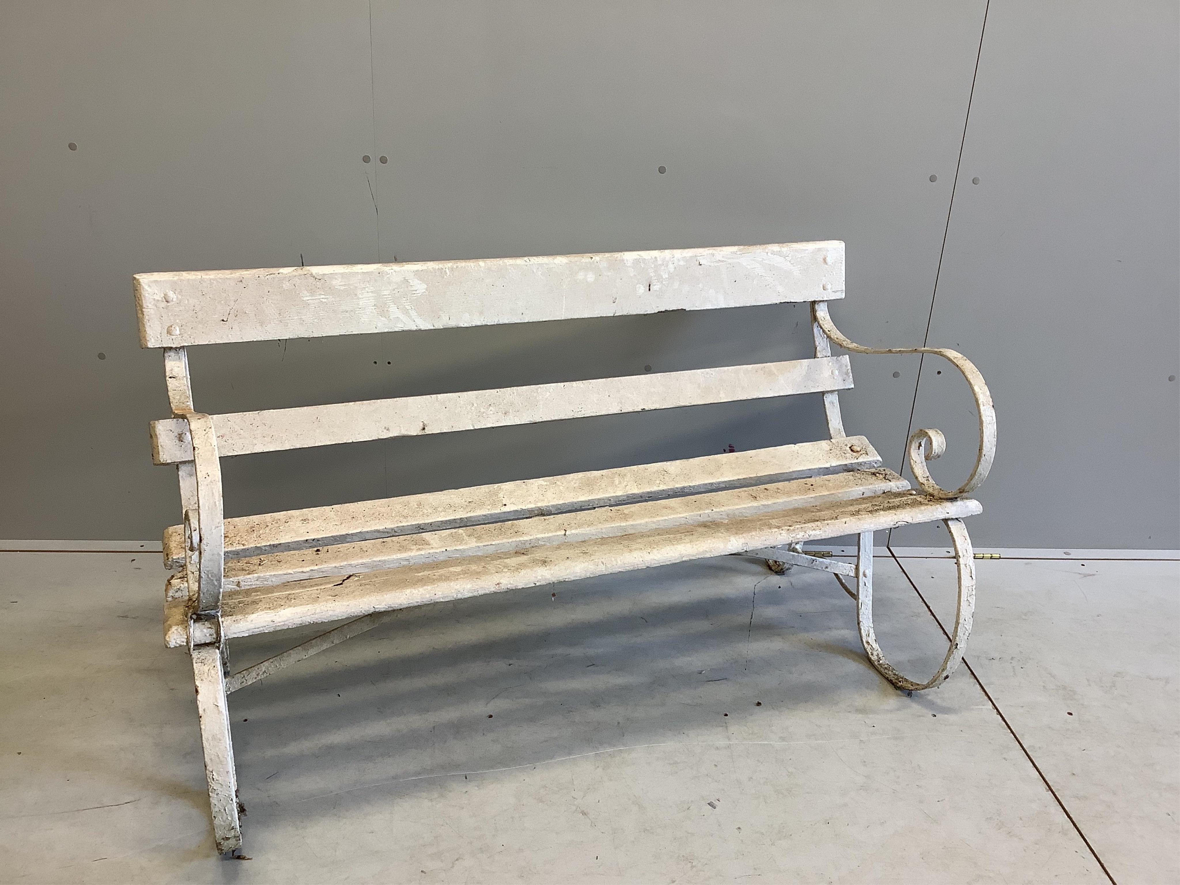 A white painted slatted wood garden bench with wrought iron ends, width 137cm, depth 63cm, height 78cm. Condition - poor to fair